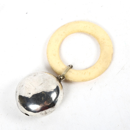 1379 - A baby's bone teething ring, with face design silver rattle