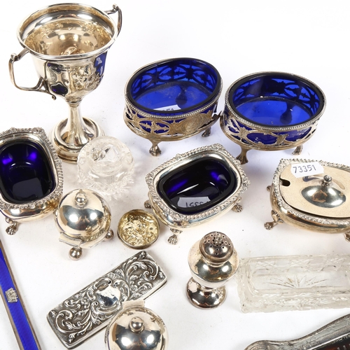 1387 - A group of silver items, to include a pair of oval engraved and pierced salts with blue liners, both... 