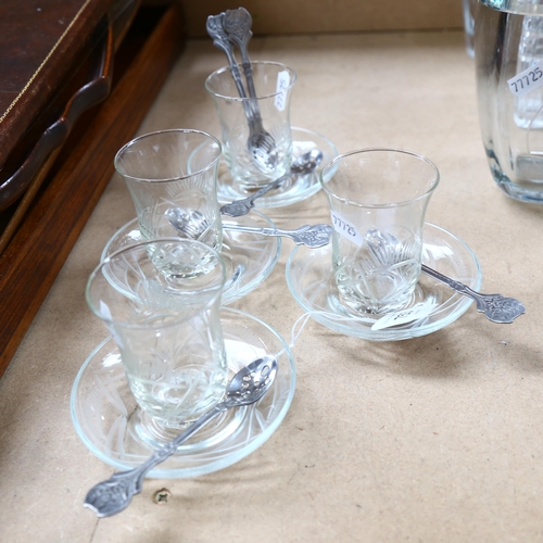 753 - A set of 4 engraved coffee glasses and saucers, with a set of 6 white metal spoons