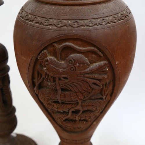 754 - A pair of carved wood dragon candlesticks and matching vase, height 37cm