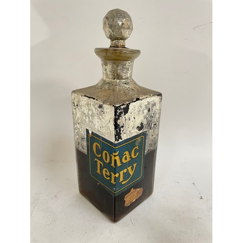 483 - A 1908 wax sealed Conac Terry decanter and contents