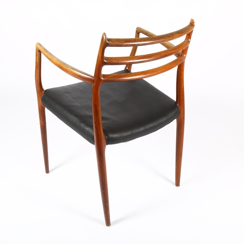 1510 - NIELS OTTO MOLLER for JL MOLLER, a Model 62 rosewood dining armchair chairs, designed 1962, with bla... 