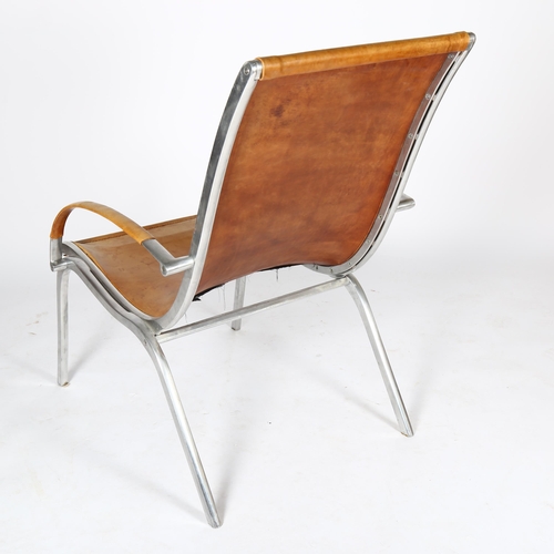 1587 - RUDOLF SZEDLECZKY, attributed, an aluminium and tan leather lounge chair, height 97cm