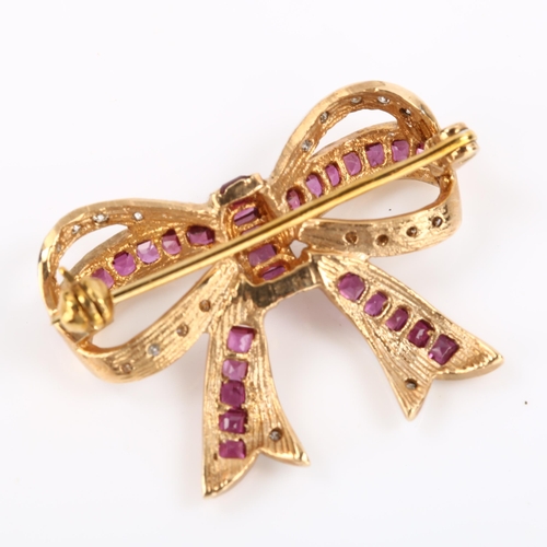 76 - A late 20th century ruby and diamond ribbon bow brooch, unmarked gold settings with square-cut ruby ... 