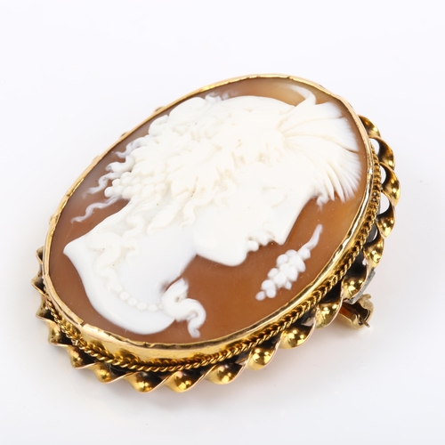 82 - A Victorian shell cameo brooch, depicting Dionysus, in unmarked gold twist frame, brooch height 43.9... 