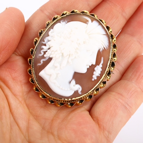 82 - A Victorian shell cameo brooch, depicting Dionysus, in unmarked gold twist frame, brooch height 43.9... 