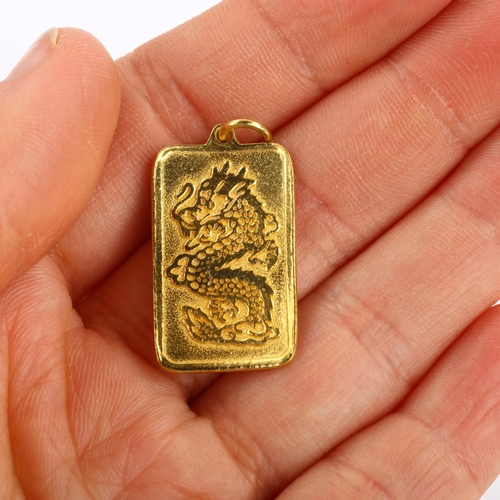 101 - A Chinese 9999 gold dragon ingot pendant, character marks verso, pendant height excluding bale 27.8m... 