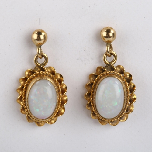 104 - A pair of 9ct gold opal drop earrings, set with oval cabochon white opal within twist surround and s... 