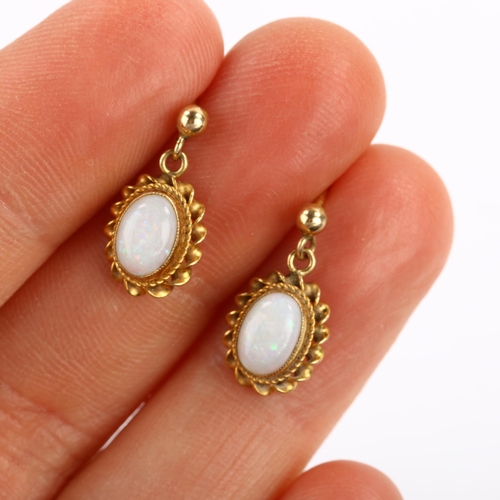 104 - A pair of 9ct gold opal drop earrings, set with oval cabochon white opal within twist surround and s... 