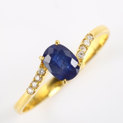 114 - A modern 14ct gold sapphire and diamond crossover ring, set with oval mixed-cut sapphire and modern ... 