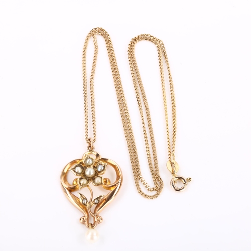 285 - An Edwardian 9ct rose gold pearl floral openwork pendant necklace, on later 9ct fine curb link chain... 