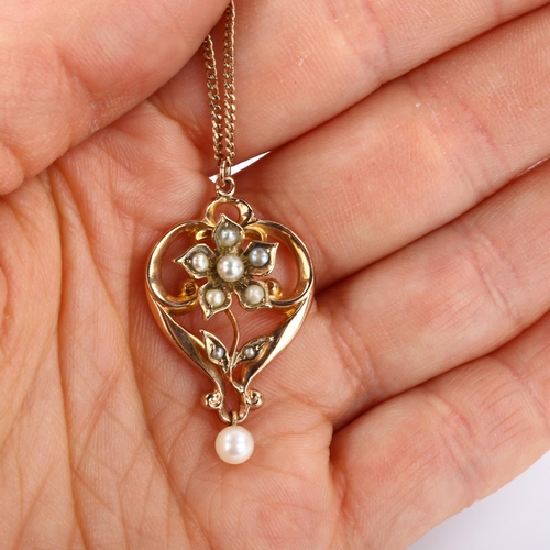 285 - An Edwardian 9ct rose gold pearl floral openwork pendant necklace, on later 9ct fine curb link chain... 