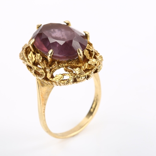 295 - A 1970s 9ct gold amethyst abstract ring, with naturalistic leaf surround and oval mixed-cut amethyst... 