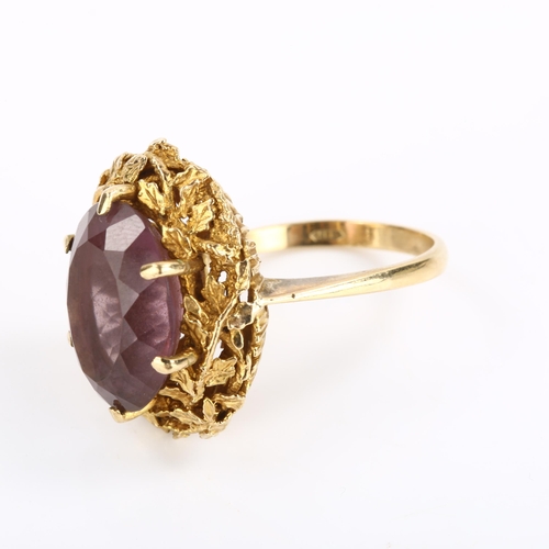 295 - A 1970s 9ct gold amethyst abstract ring, with naturalistic leaf surround and oval mixed-cut amethyst... 