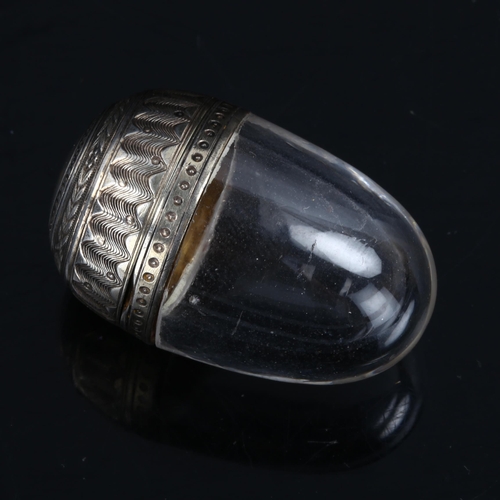 305 - A miniature French silver-mounted glass egg vinaigrette, engraved and engine turned decoration, with... 