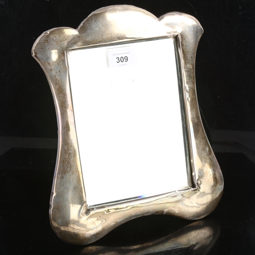 309 - An Edwardian silver-fronted dressing table strut mirror, shaped surround with original plate glass m... 