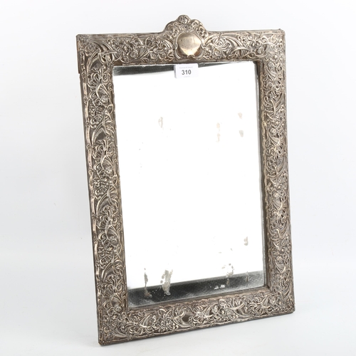 310 - A large Edwardian silver-fronted rectangular dressing table strut mirror, embossed floral decoration... 