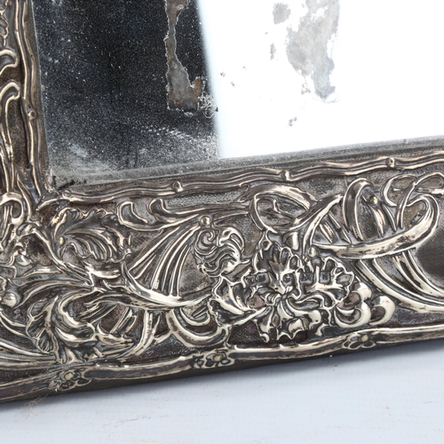 310 - A large Edwardian silver-fronted rectangular dressing table strut mirror, embossed floral decoration... 