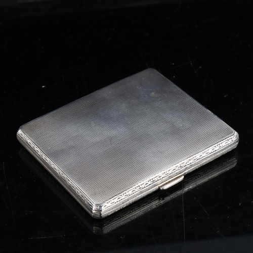 323 - A George V square silver cigarette case, allover engine turned decoration with foliate border, by Co... 