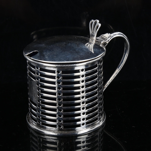 329 - A George V silver drum mustard pot, pierced decoration with thumbpiece and blue glass liner, by Phil... 