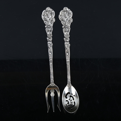 336 - GORHAM - an American sterling silver matching sifter spoon and bread fork, cast cherub decoration, l... 