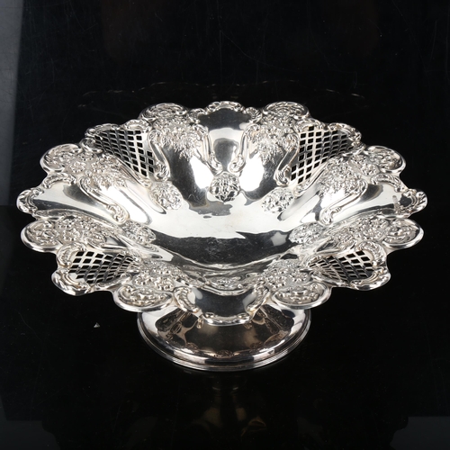 357 - An Edwardian silver pedestal fruit bowl/tazza, with relief embossed floral and pierced lattice decor... 