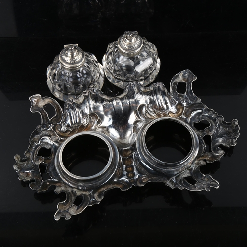 358 - A Victorian silver Rococo style desk ink stand, with original fitted glass ink wells and pen tray, b... 