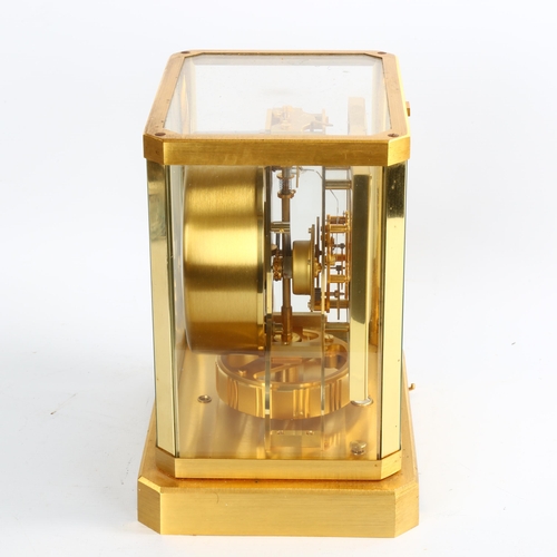 2 - JAEGER LECOULTRE - a gilt-brass Atmos clock, square white lacquered dial with quarterly Arabic numer... 