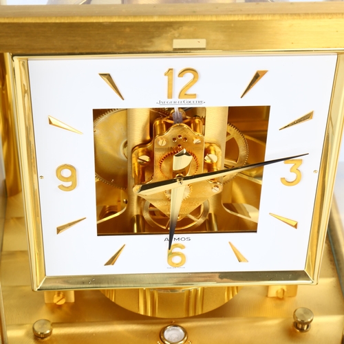 2 - JAEGER LECOULTRE - a gilt-brass Atmos clock, square white lacquered dial with quarterly Arabic numer... 