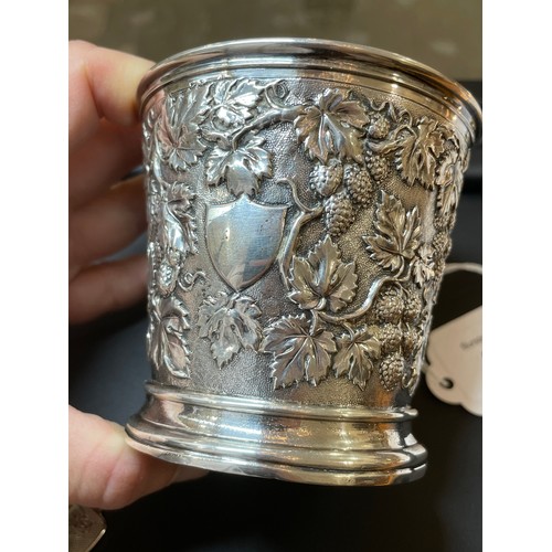 337 - A Victorian silver grapevine mug, relief embossed and chased decoration with vine handle and gilt in... 