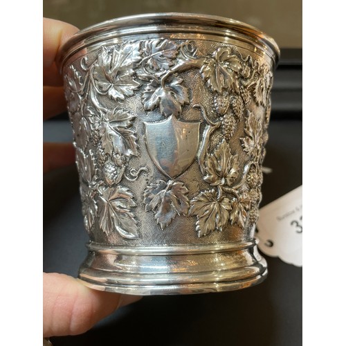 337 - A Victorian silver grapevine mug, relief embossed and chased decoration with vine handle and gilt in... 