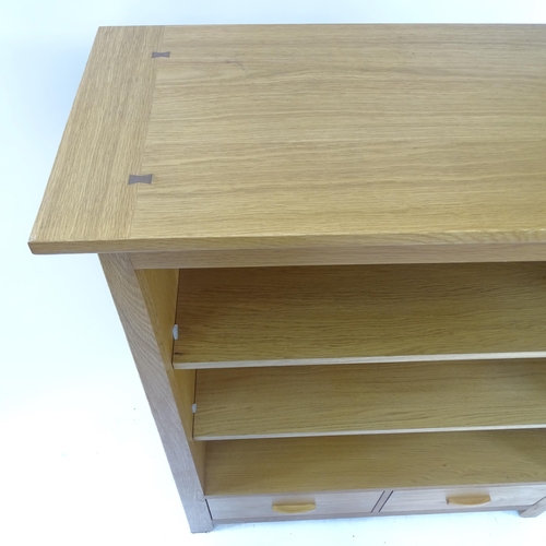 2081 - A modern light oak bookcase, with 2 adjustable shelves and 2 fitted drawers, W105cm, H128cm, D41cm