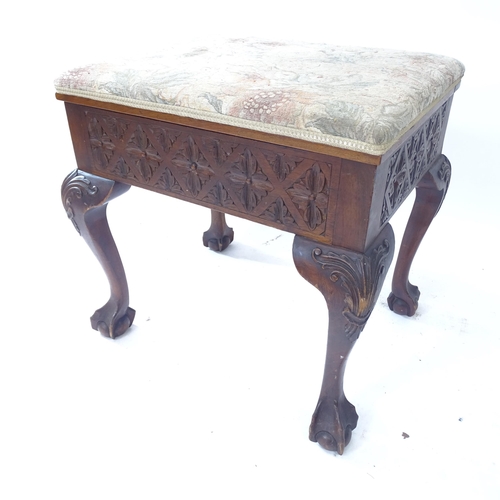 2085 - A 19th century mahogany piano stool, with carved decoration, on cabriole legs with claw and ball fee... 