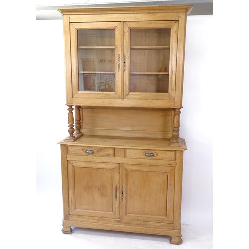 2106 - A Continental pine 2-section buffet, W130cm, H230cm, D42cm (with key)