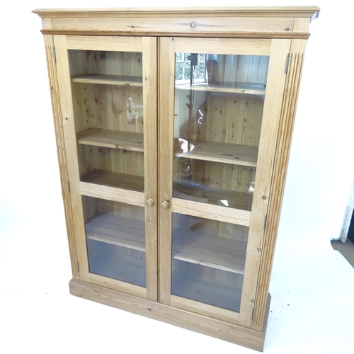 2149 - A modern pine 2-door bookcase, with 1 fitted and 3 adjustable shelves, W126cm, H168cm, D35cm