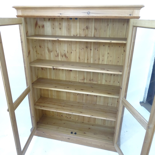 2149 - A modern pine 2-door bookcase, with 1 fitted and 3 adjustable shelves, W126cm, H168cm, D35cm