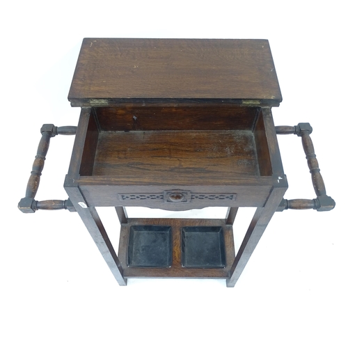 2156 - An early 20th century oak stick/umbrella stand, with drip trays, W69cm, H76cm, D26cm