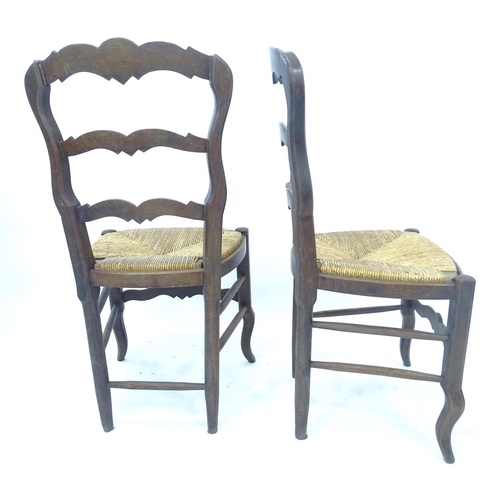 2172 - A set of 4 French oak rush-seated ladder-back dining chairs