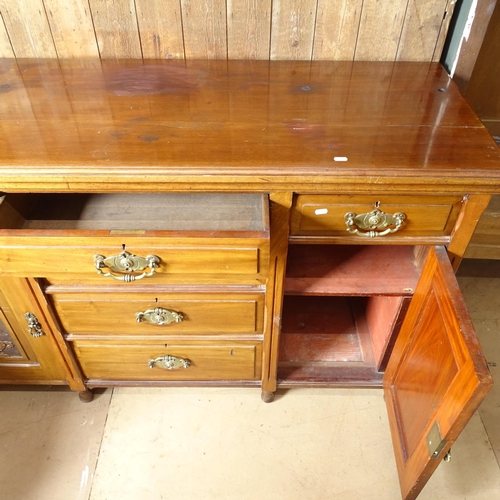 2181 - An early 20th century Art Nouveau mahogany dresser base, with 6 drawers and 2 cupboards, with carved... 