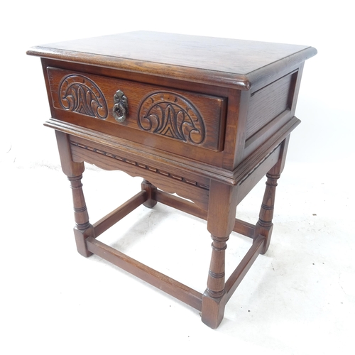 2378 - A reproduction oak lamp table, with single frieze drawer and carved decoration, W57cm, H65cm, D43cm