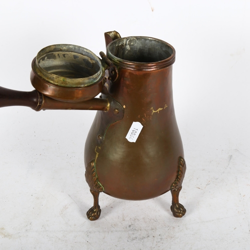 485 - Antique copper chocolate pot on tripod supports, with turned wood handle, 26cm