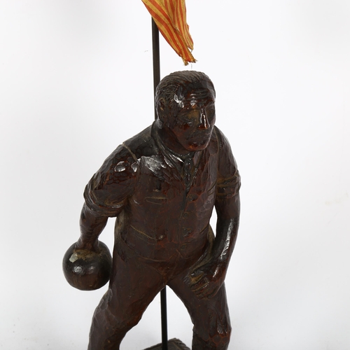 486 - A Spanish carved wood figure of a bowler, inscribed Barcelona 1928, height overall 45cm