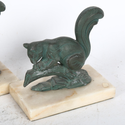 489 - A pair of verdigris patinated spelter squirrel figure bookends, on marble plinths, height 14cm