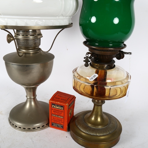 514 - An oil lamp with chimney and milk glass shade, height 62cm, and another oil lamp, with glass font an... 