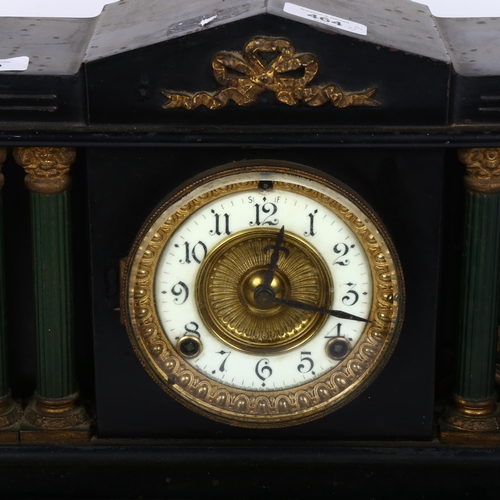 559 - A black mantel clock, with brass dial and 2-train movement, height 29cm