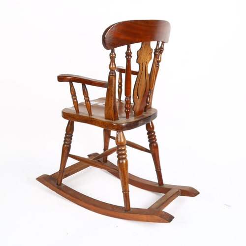 585 - A Windsor style doll's rocking chair