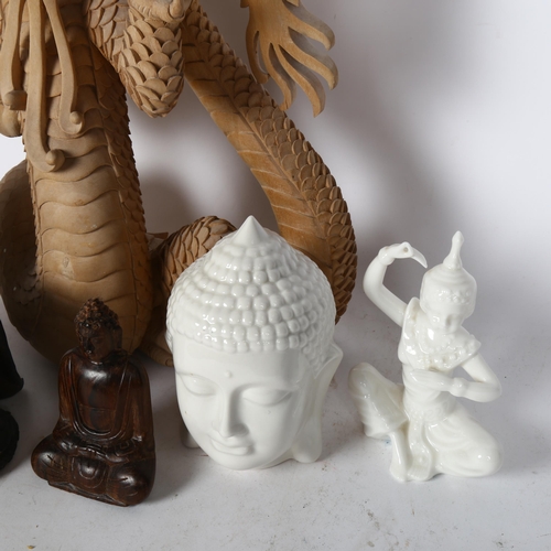 215 - A Chinese carved dragon, a modern concept Buddha figure, a carved wood Buddha figure, and a ceramic ... 