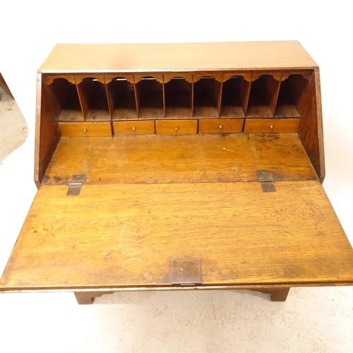 2536 - A Georgian oak bureau, the fall-front revealing fitted interior with 4 long drawers below, on bracke... 