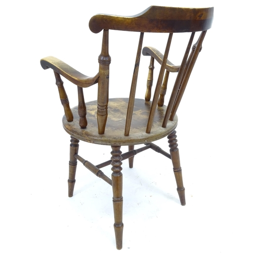 2549 - An Antique mahogany and elm-seated stick-back elbow chair