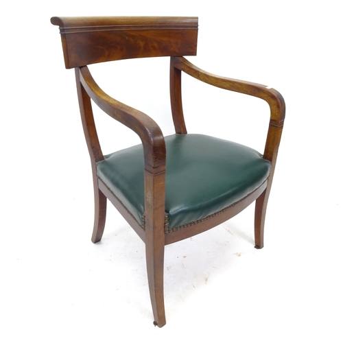 2552 - A Victorian mahogany open-arm desk chair, with green faux leather upholstery